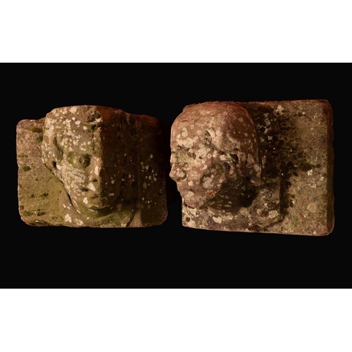 1600 - A pair of Medieval stone corbels, carved as the head of a man and a woman, facing to left and right,... 