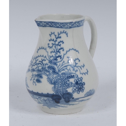 62 - A Liverpool baluster cream jug, decorated in underglaze blue with hut fence and foliage, banded trel... 