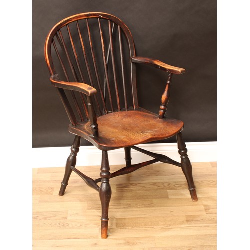 148 - A 19th century elm and ash Windsor elbow chair, arched stick back, serpentine arms, saddle seat, tur... 