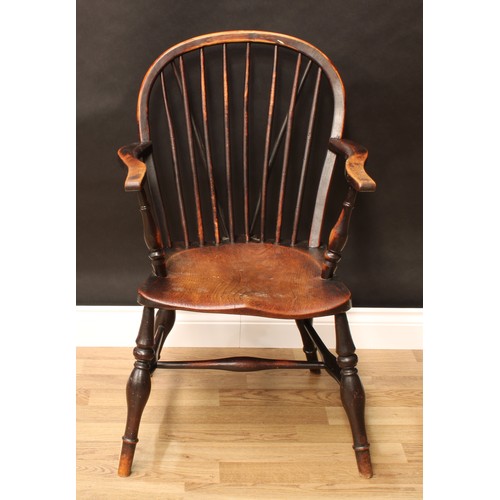 148 - A 19th century elm and ash Windsor elbow chair, arched stick back, serpentine arms, saddle seat, tur... 