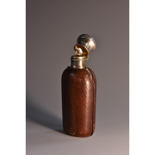 1800 - An early 20th century French silver mounted leather-clad scent bottle, hinged domed cover enclosing ... 