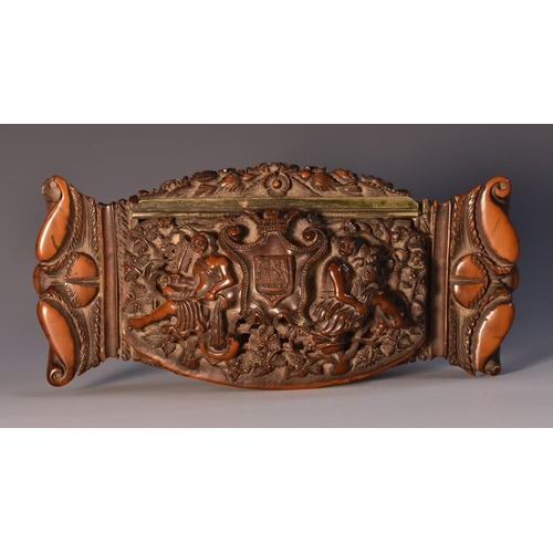 1815 - A late 18th century coquilla nut snuff box, hinged cover carved with allegorical figures flanking ma... 