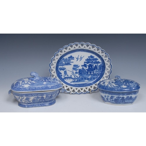 78 - A Spode Willow pattern canted rectangular sauce tureen and cover, typically printed with pagoda, fen... 