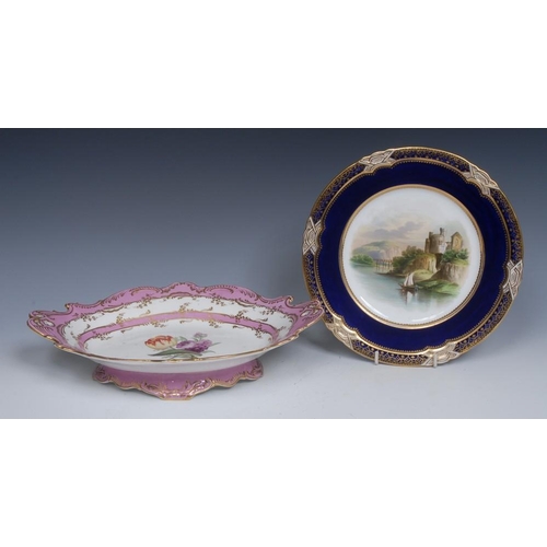 86 - An English porcelain shaped oval two handled pedestal dish, painted with a tulip and other flower un... 