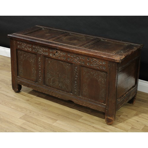 208 - A Charles II oak three-panel blanket chest, hinged top, the front carved with strapwork, a shell mot... 