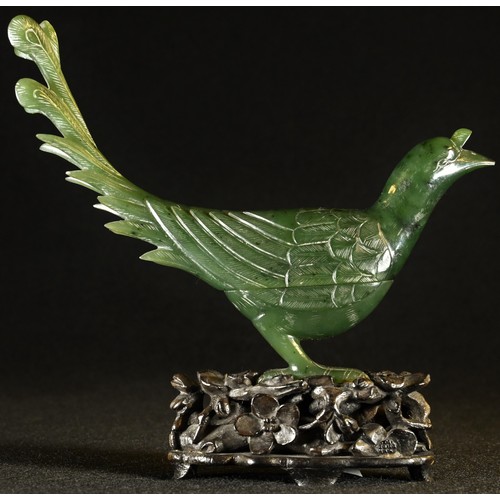 5102 - A Chinese spinach jade box and cover, carved as a bird, hardwood stand, 12cm high