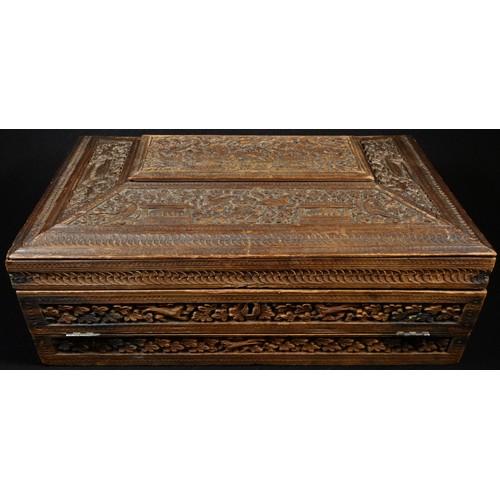 5039 - A 19th century Indian sandalwood sarcophagus combination work and writing box, profusely carved with... 