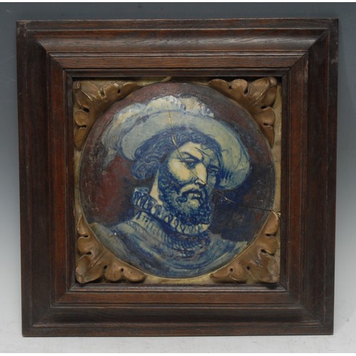 5311 - An Italian maiolica panel, painted with a portrait of a bearded gentleman wearing a ruff and a feath... 