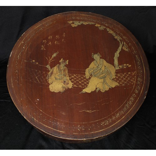 5092 - A Chinese lacquer circular box and cover, decorated in gilt with figures before trellis, 31cm diam, ... 