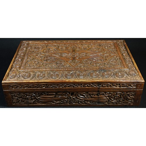 5308 - An Indian sandalwood rectangular box, profusely carved with stylised flowers and scrolling leafy ste... 