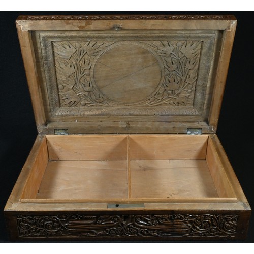 5308 - An Indian sandalwood rectangular box, profusely carved with stylised flowers and scrolling leafy ste... 