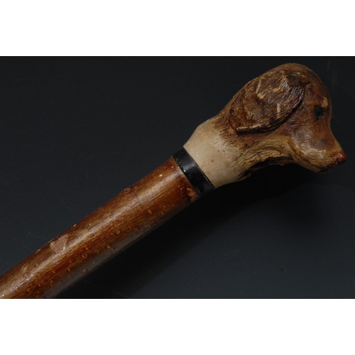 5072 - A Black Forest style fell walking stick, the pommel as the head of a spaniel dog, 125cm long; anothe... 