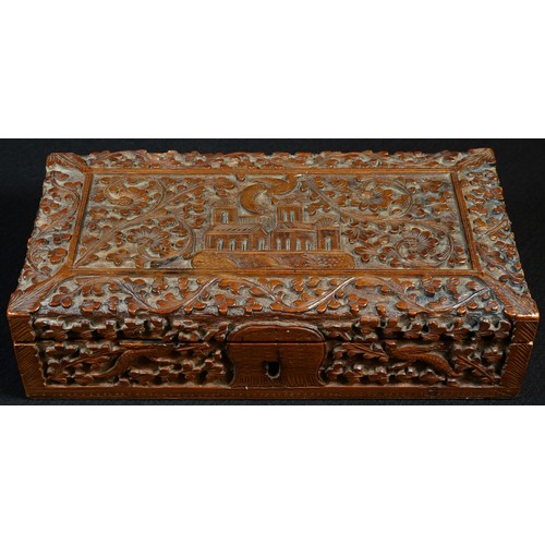 5307 - An Indian sandalwood rectangular box, carved with a temple on a ground of scrolling flowering foliag... 