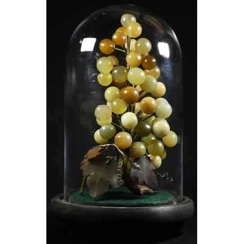 5086 - A Chinese hardstone arrangement, carved and formed as a bunch of grapes, 23cm high, glass dome with ... 