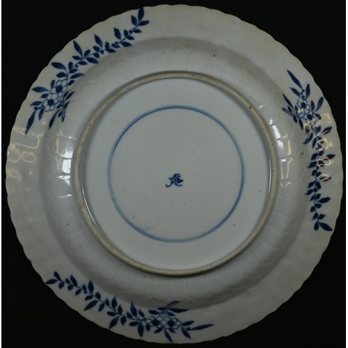 5099 - A Chinese shaped circular charger, painted in underglaze blue, the centre with five fish on a styliz... 