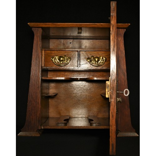 5272 - An Art Nouveau oak gentleman's smoking room cabinet, hinged cover and bevelled glazed door enclosing... 