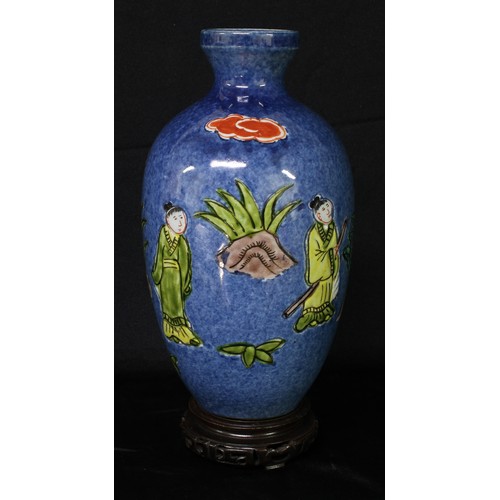 5095 - A Chinese ovoid vase, painted in polychrome with figures holding a scroll, beneath a banner inscribe... 