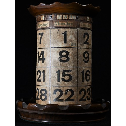 5283 - An early 20th century combination desk top pen tidy and perpetual calendar, printed card cylinder, t... 