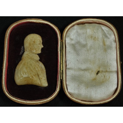 5065 - A 19th century wax portrait, of a gentleman, bust length, 5.5cm x 3.5cm, red morocco travelling case