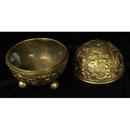 5288 - An early 20th century gilt metal globular string box, cast in relief with scrolling leafy strapwork,... 