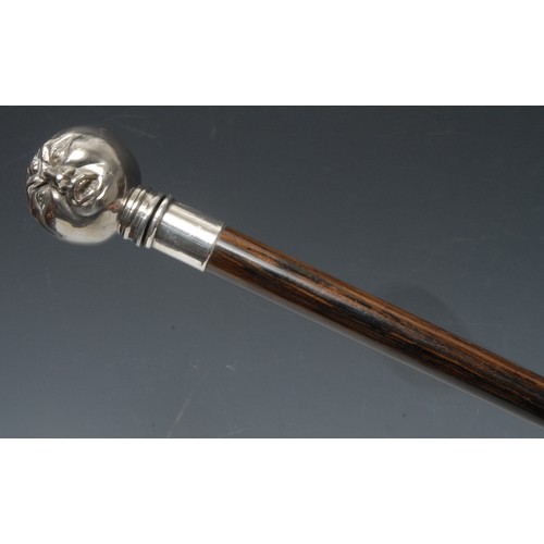 5115 - A gentleman's novelty walking cane, enclosing a corkscrew, the comical silver plated pommel as a fac... 