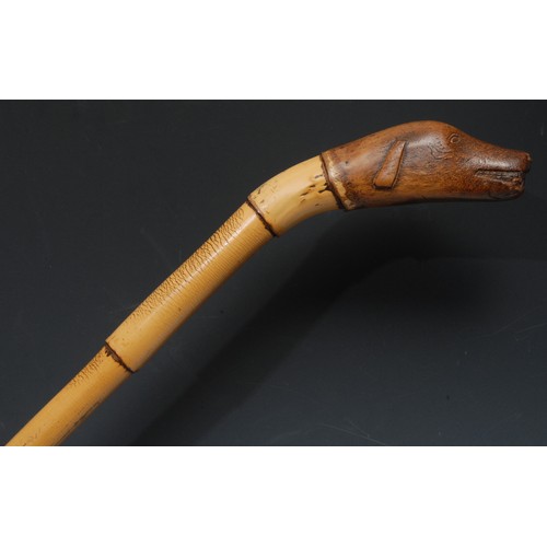 5292 - An early 20th century novelty walking stick, the pommel carved as the head of a dog, bamboo cane, 98... 