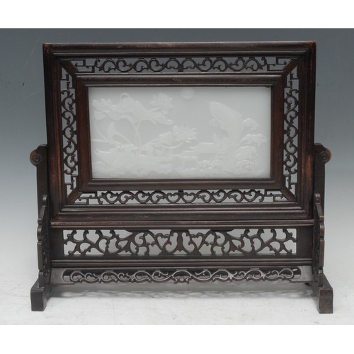 5096 - A Chinese pale jade and hardwood table screen, the rectangular panel carved in high relief with a la... 