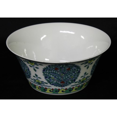 5103 - A Chinese wucai flared bowl, painted with stylised trees, flowers and scroll lappets, 16cm diam, sea... 