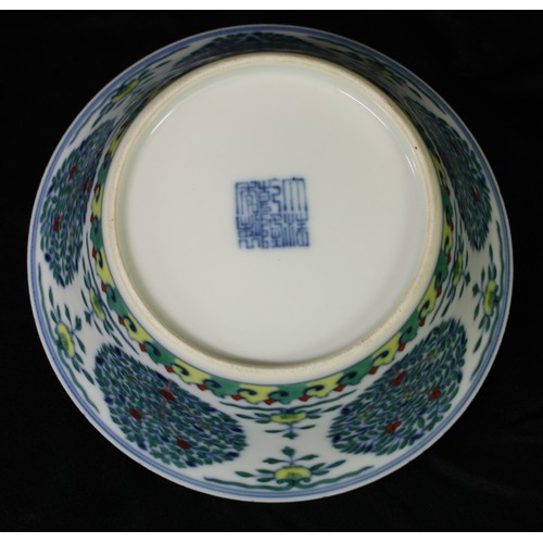 5103 - A Chinese wucai flared bowl, painted with stylised trees, flowers and scroll lappets, 16cm diam, sea... 