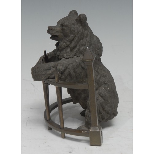 5059 - A 19th century Russian brown patinated bronze novelty inkwell, as a bear standing at railings, his h... 