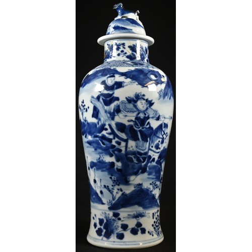 5079 - A Chinese baluster vase and cover, painted in underglaze blue with mounted warriors in stylized land... 