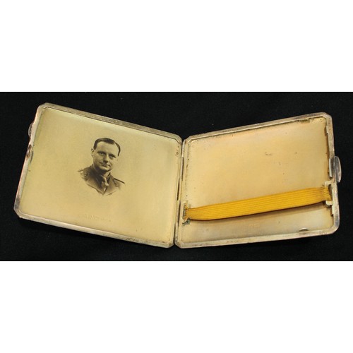 314 - Military Interest - a George V silver shaped rectangular cigarette case, the interior with a photogr... 