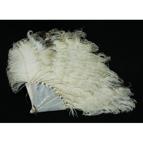 5313 - An orange ostrich feather fan, faux tortoiseshell sticks, 70cm long; another (2)