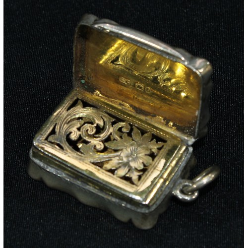 337 - A Victorian shaped rectangular silver vinaigrette, the hinged cover enclosing a gilt interior with p... 