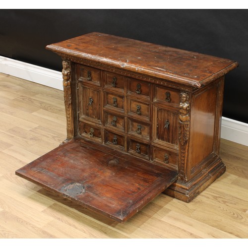 346 - An 18th century Italian walnut table cabinet, oversailing top above a fall front enclosing cupboards... 