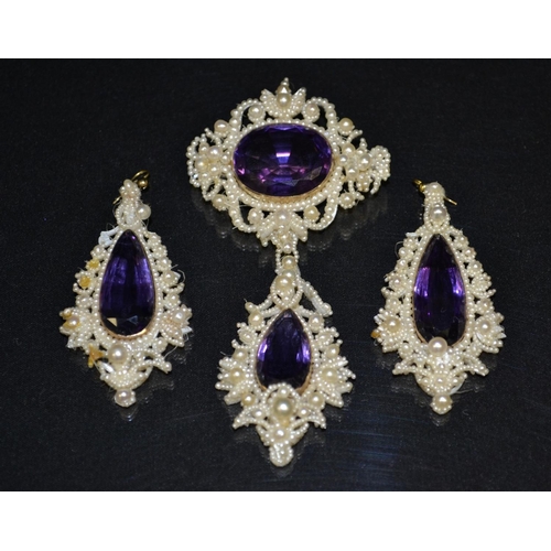 3052 - An amethyst and seed pearl pendant brooch and earring suite, comprising, a brooch with oval amethyst... 