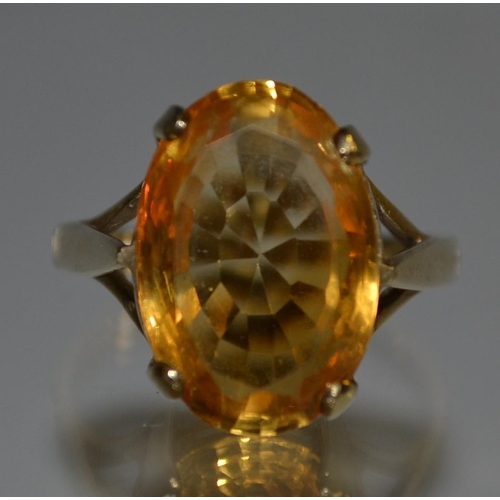 3054 - A citrine dress ring, single oval orangey yellow citrine, quarter claw set to a 9ct gold shank, size... 