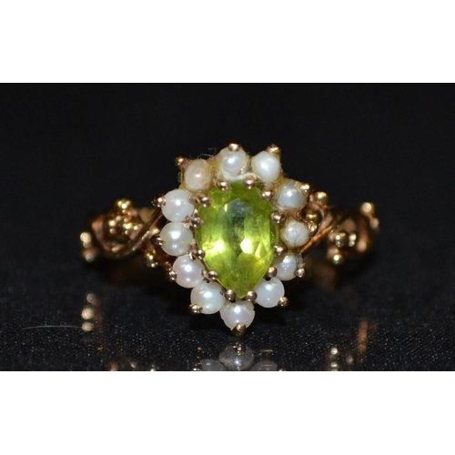 3062 - A peridot and seed pearl cluster ring, central teardrop peridot, surrounded by a band of twelve mabe... 