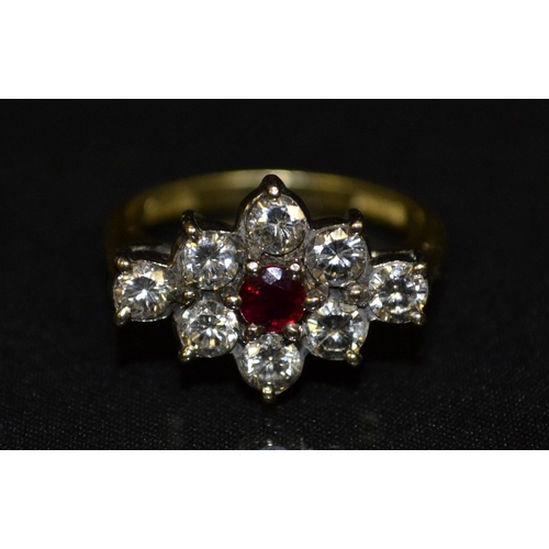 3115 - A diamond and ruby cluster ring, central raised round cut ruby, approx 0.15ct, surrounded by a diamo... 