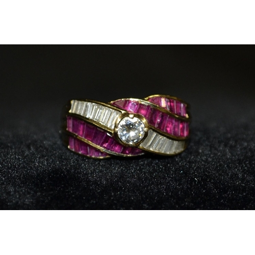 3116 - A diamond and ruby cluster ring, central round brilliant cut diamond, framed by two rows of nine irr... 