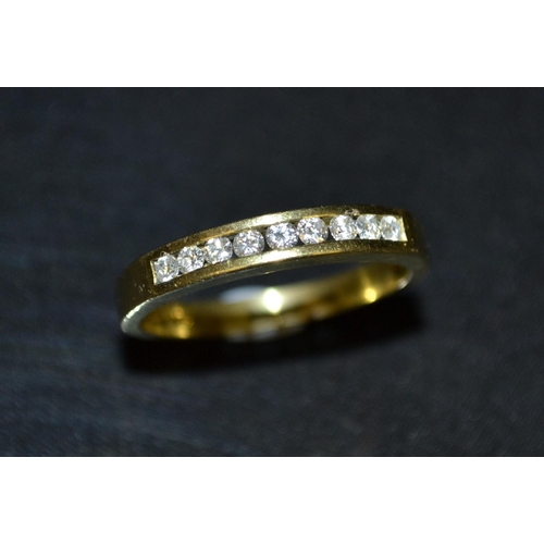 3131 - A diamond nine stone half eternity ring, channel set with nine round brilliant cut diamonds, total d... 