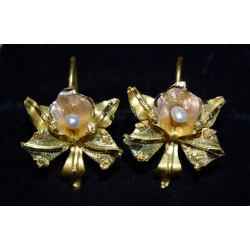 3132 - A pair of high carat gold and seed pearl earrings, each with an open multi-layer flower head, set wi... 