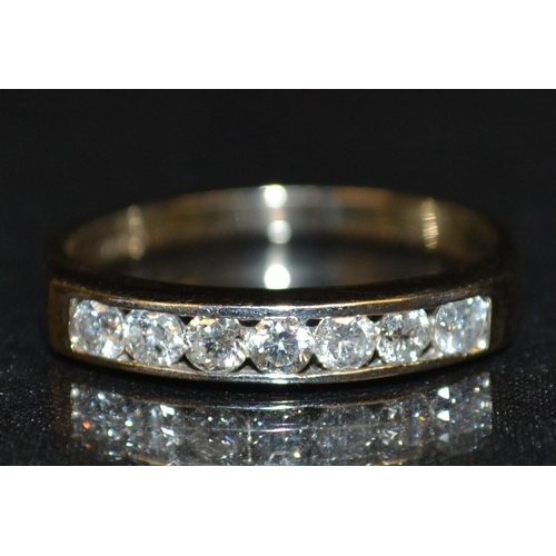 3183 - A new seven stone diamond half eternity ring, channel set with seven round brilliant cut diamonds, t... 