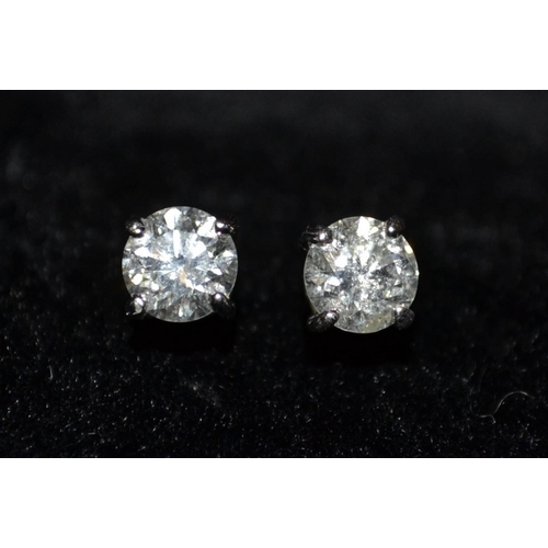 3184 - A pair of diamond stud earrings, each round brilliant cut diamond approx 0.50ct total diamond weight... 