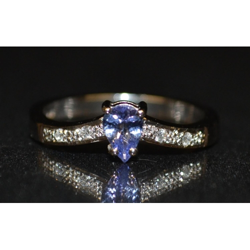 3189 - A new tanzanite and diamond ring, central pale blue/purple teardrop tanzanite,inverted shoulder encr... 