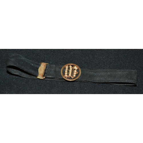 3251 - A 15ct gold and black silk garter slide, adjustable black silk band with sliding 15ct gold and seed ... 