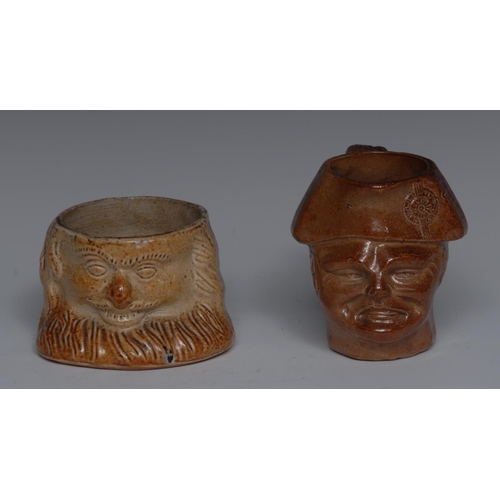 118 - A mid 19th century Derbyshire brown salt glazed stoneware character jug, of a grotesque man, wearing... 