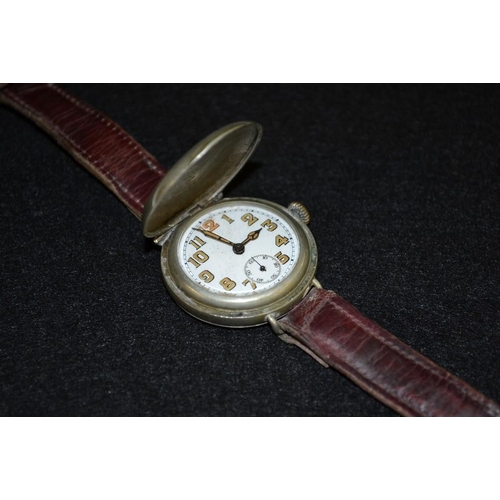 3091 - An early 20th century Swiss Trench wristlet watch, fully enclosed cover, white dial, luminous Arabic... 