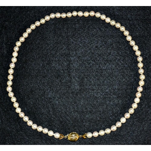 3154 - A cultured pearl single strand necklace, each individually knotted, united by a diamond and 18ct gol... 