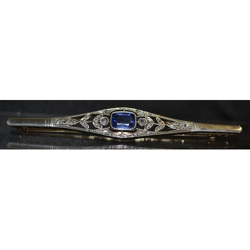 3165 - An Edwardian diamond and sapphire paste brooch, central blue paste sapphire effect baguette, open fl... 